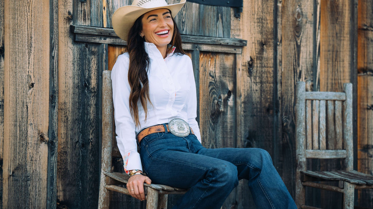Woman wearing a white OG western shirt with a standing collar and turn-back cuffs