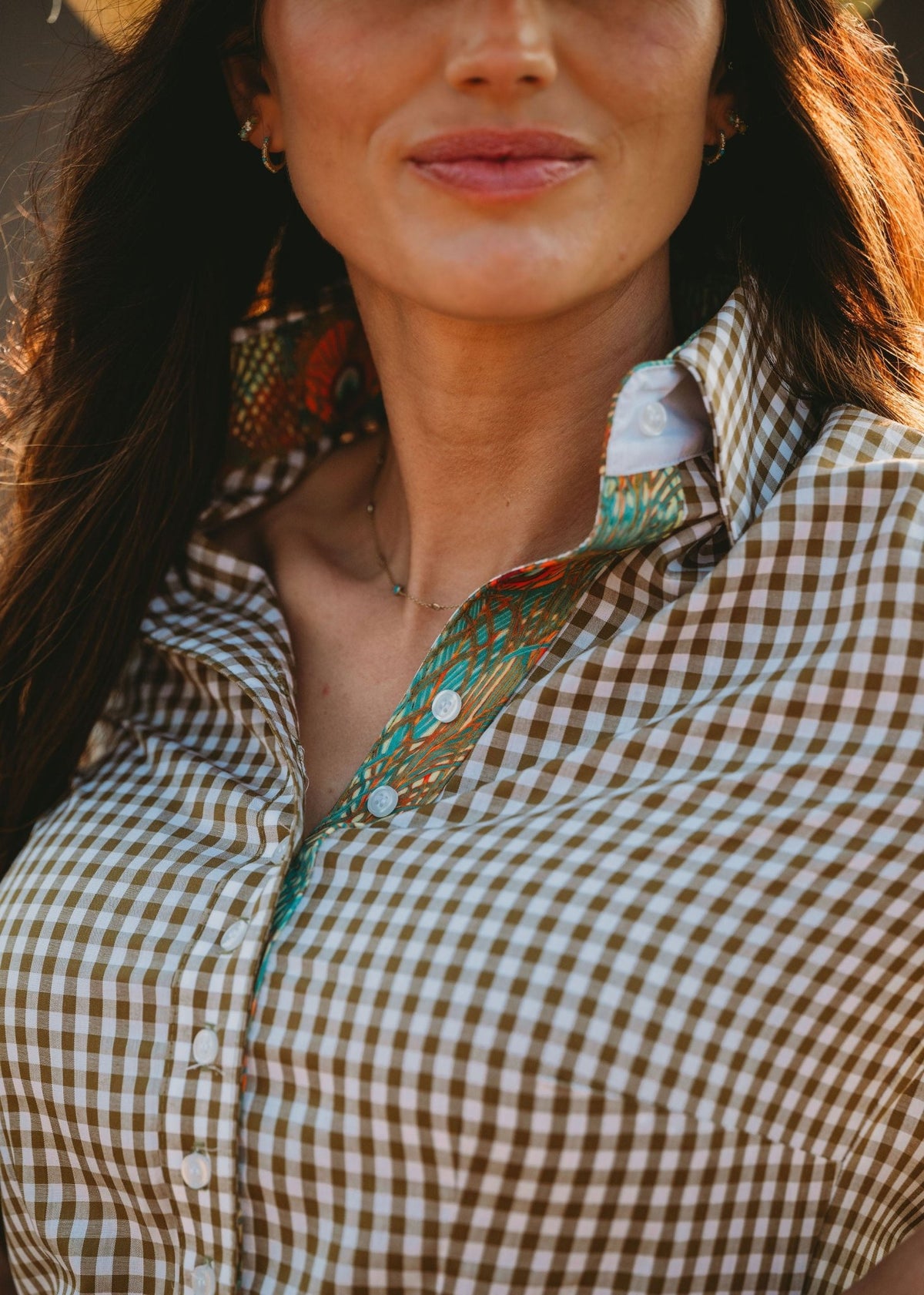 Close up of tailored olive gingham western show shirt with peacock accent print