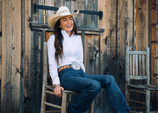 Woman wearing a white OG western shirt with a standing collar and turn-back cuffs