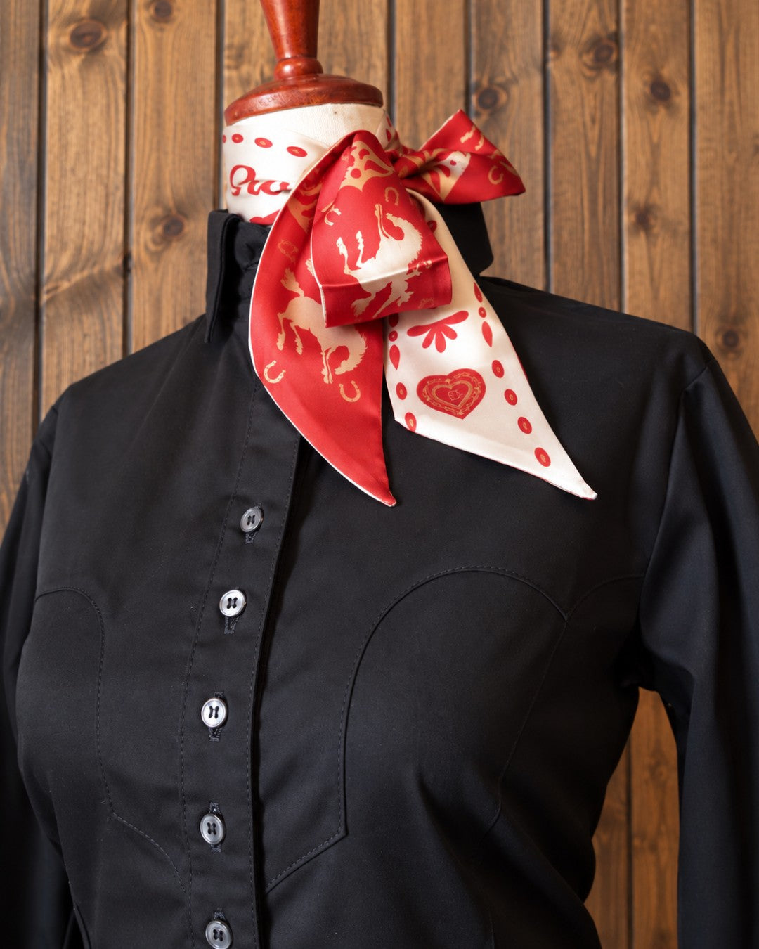 Black western shirt styled with a red and cream wild rag for a cutting horse show