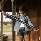 Big Concho Twilly in Black held outstretched showing full length silver concho and turquoise pattern