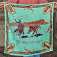 Get Along Little Doggie Wild Rag held outstretched showing full cowboy roping longhorn design in mint, tan, and brown