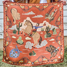 Happy Trails Wild Rag held outstretched showing full retro cowgirl on horseback design in cayenne, cream, and black