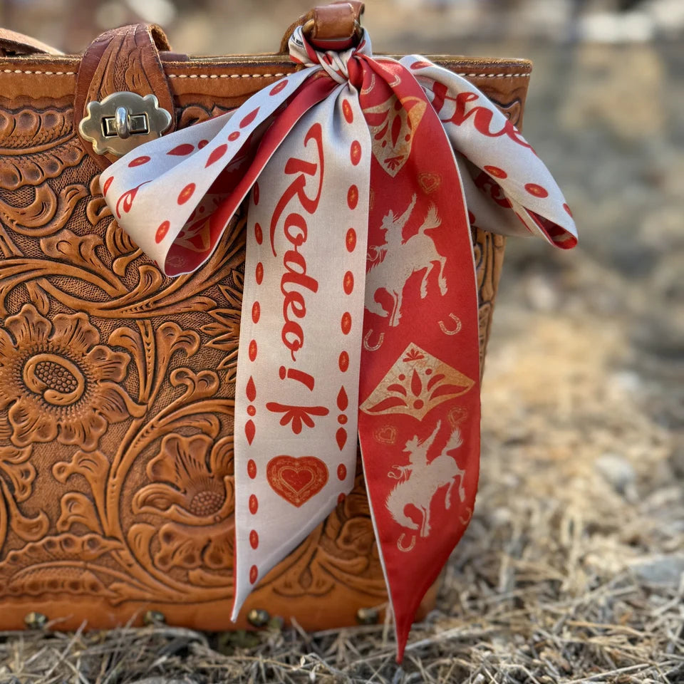 Sweetheart of the Rodeo Twilly in Vintage Red held outstretched showing full length double-sided design